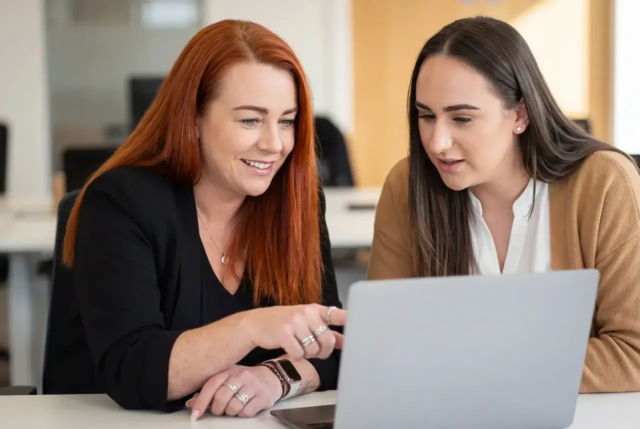 Two PurpleTree HR advisors reviewing a case together at a laptop